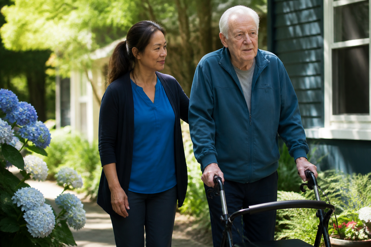 Filipina Caregiver Walking with Elderly Man in Suburban Garden